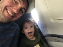 G and Dad on the plane, 3 rows behind us.